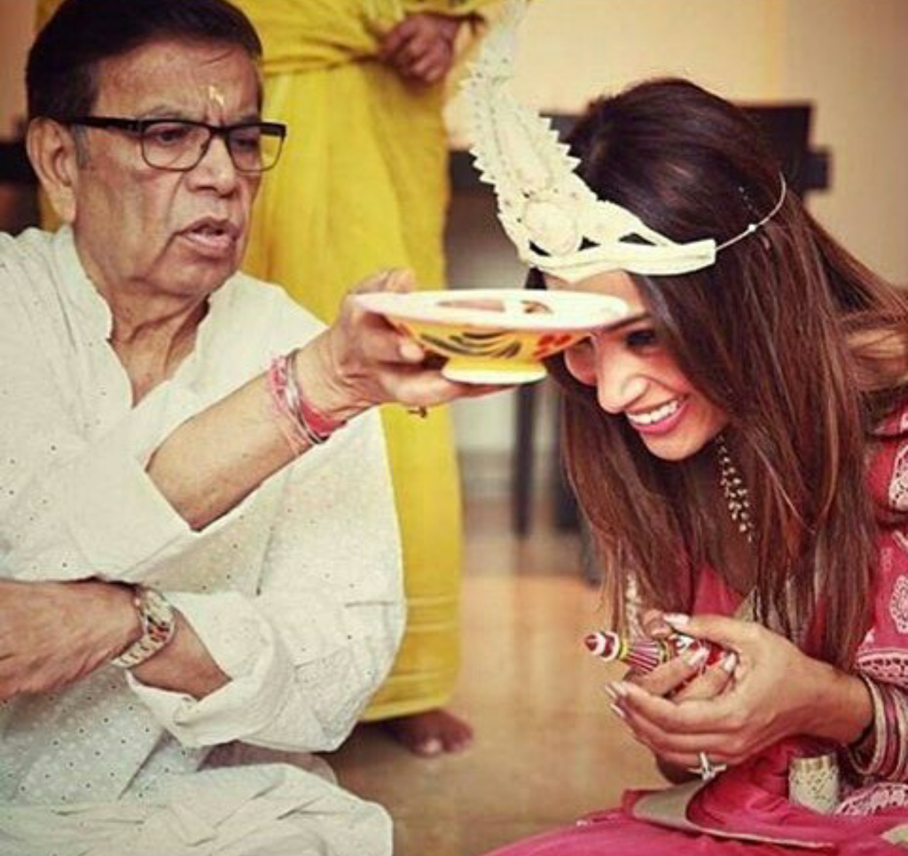 Bipasha wearing a traditional Bengali headdress called 'Mukut' with her dad